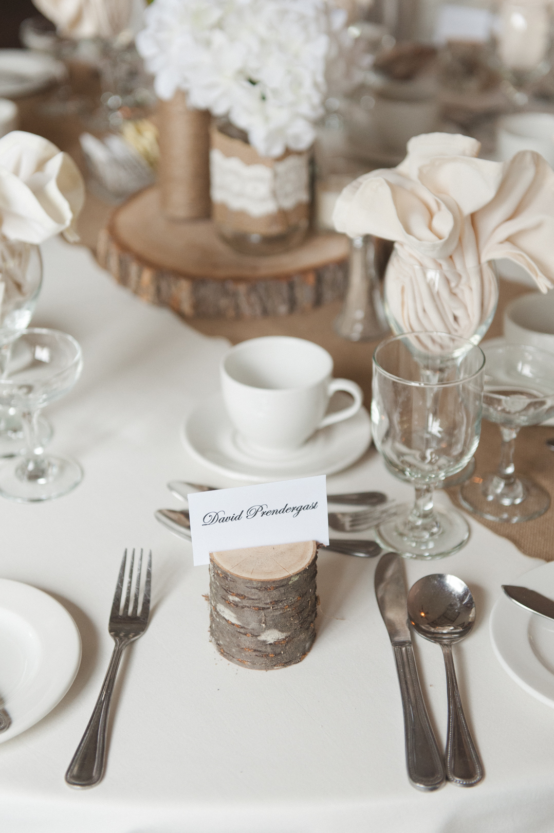 wooden stumps with name tags with place setting