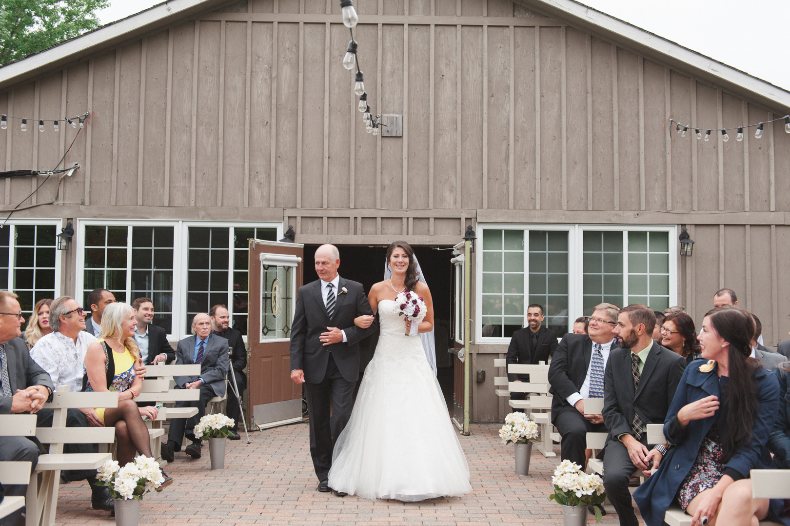 bride walking down the aisle with her father at the garden house in strathmere