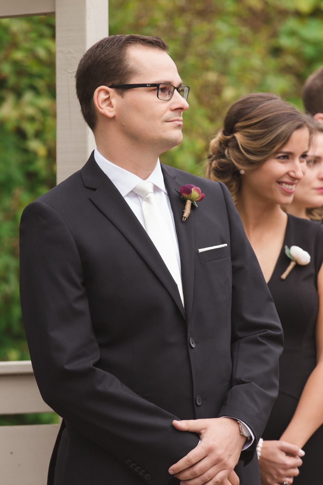 groom looking at his bride walking down the aisle