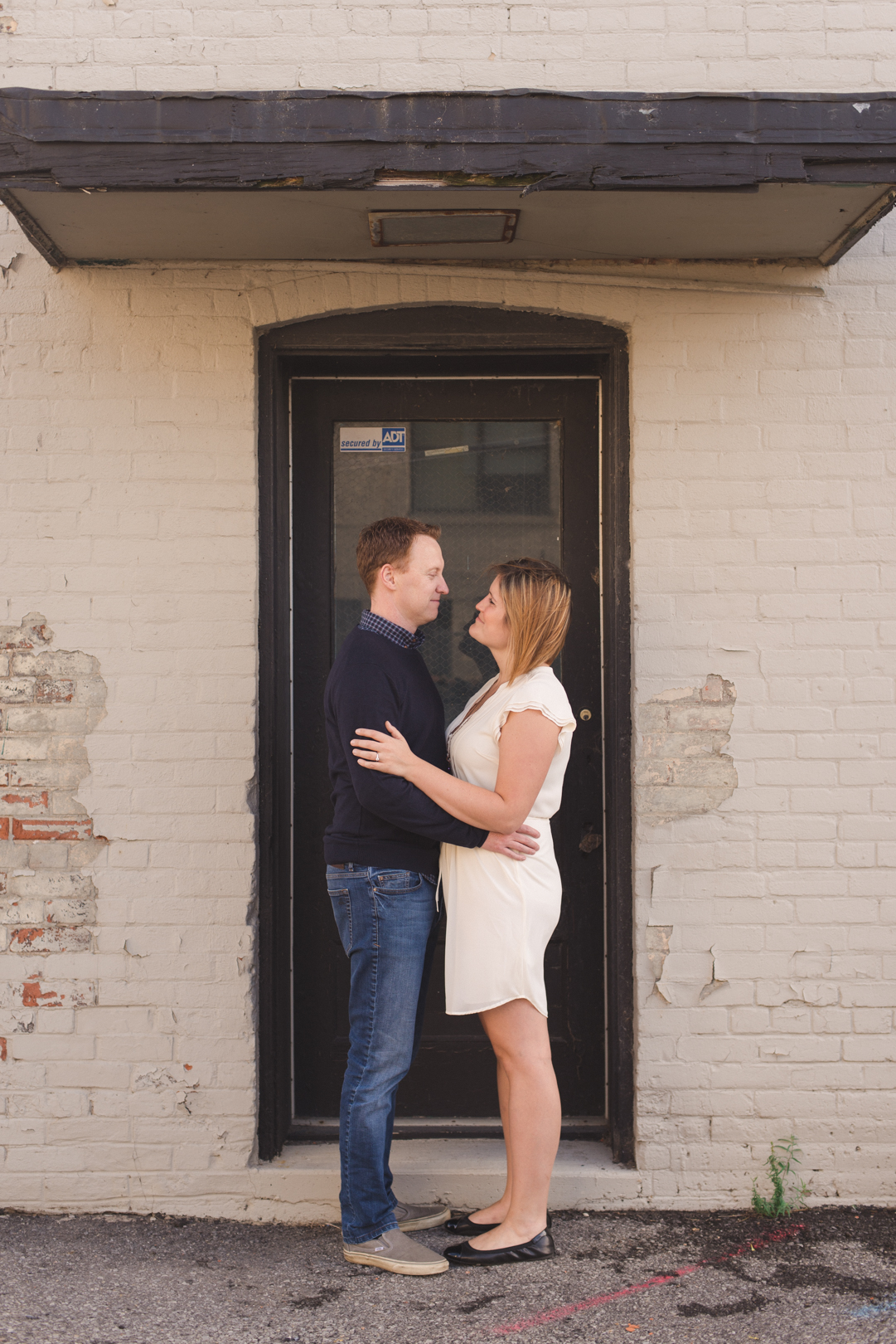 couple standing in black door frame