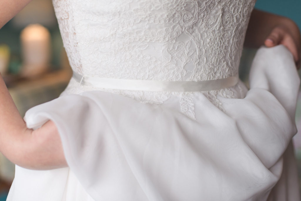 bride holding up her dress from with love bridal