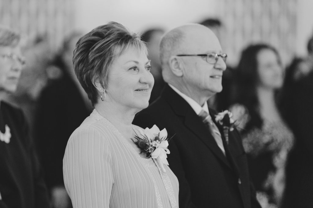 parents looking on as their son gets married