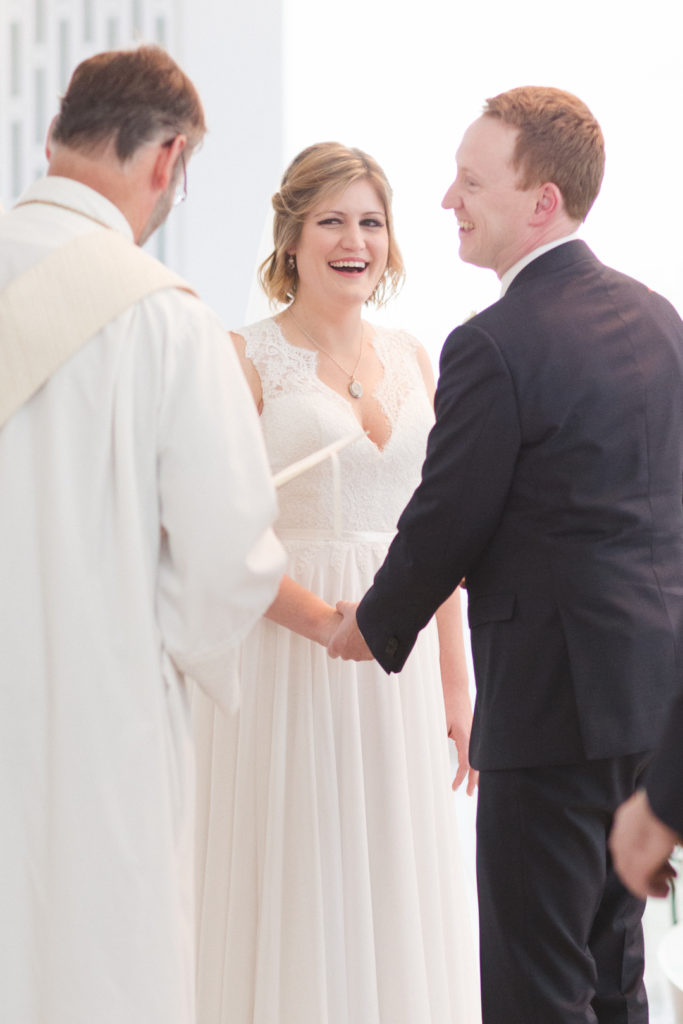 bride smiling at her groom during wedding ceremony at st basils parish church in ottawa