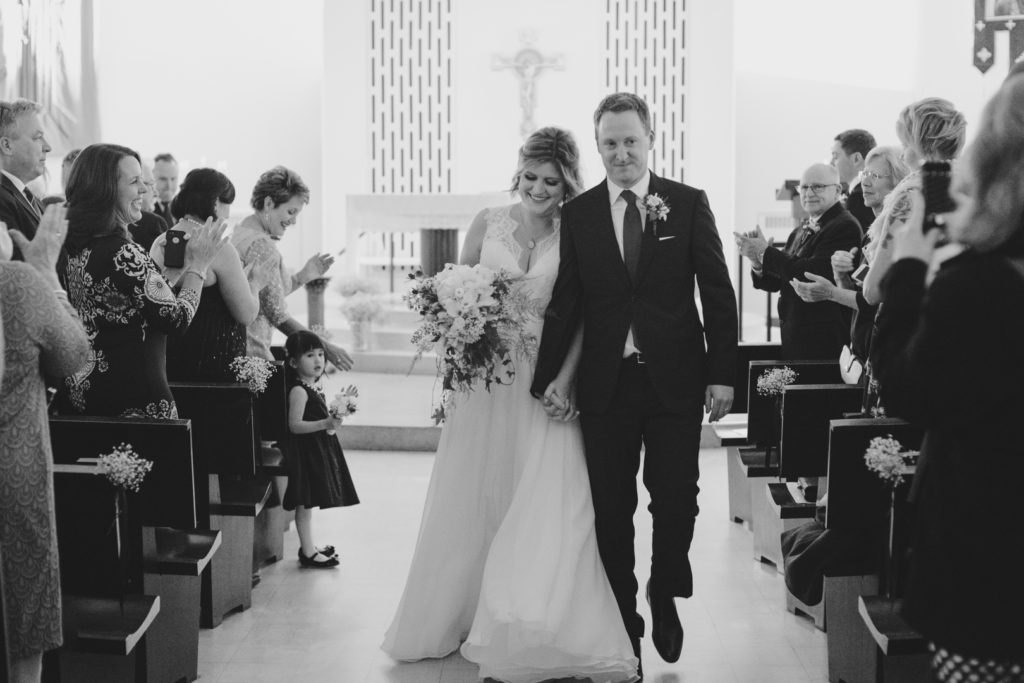 bride and groom walking down the aisle as man and wife after wedding ceremony
