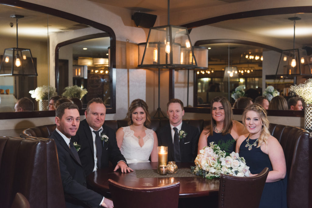 wedding party sitting in booth at luxe bistro in ottawa