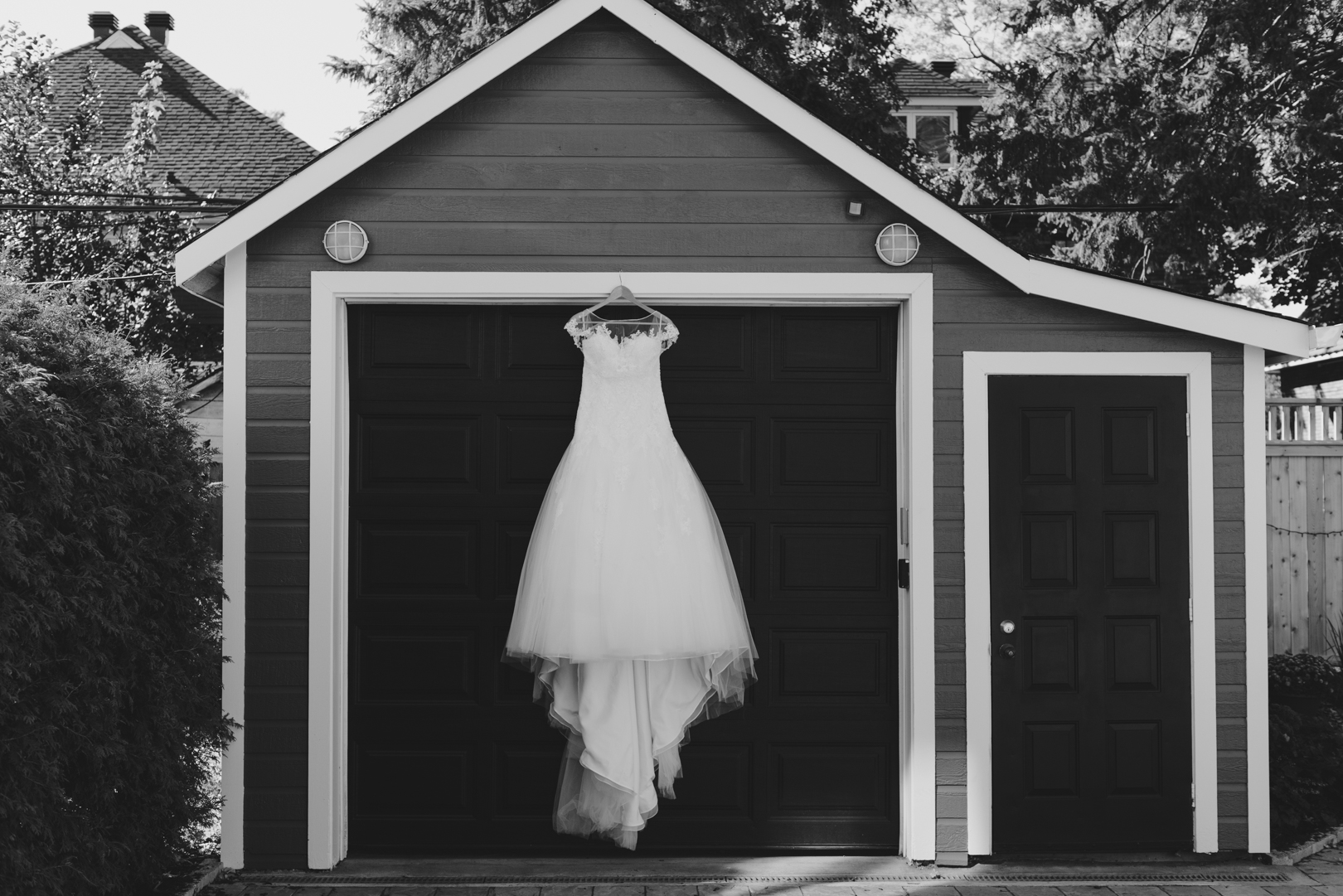 bride's dress hanging from the modern garage door