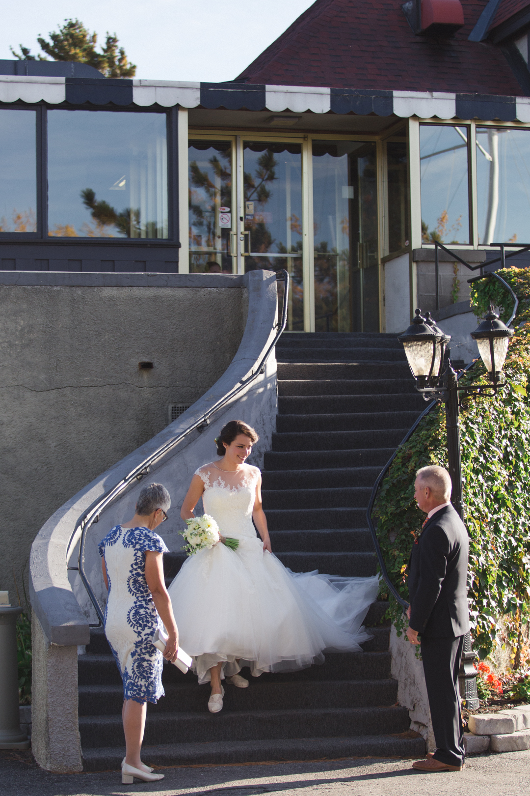 Bride walking down the stairs of the Britannia Yacht Club