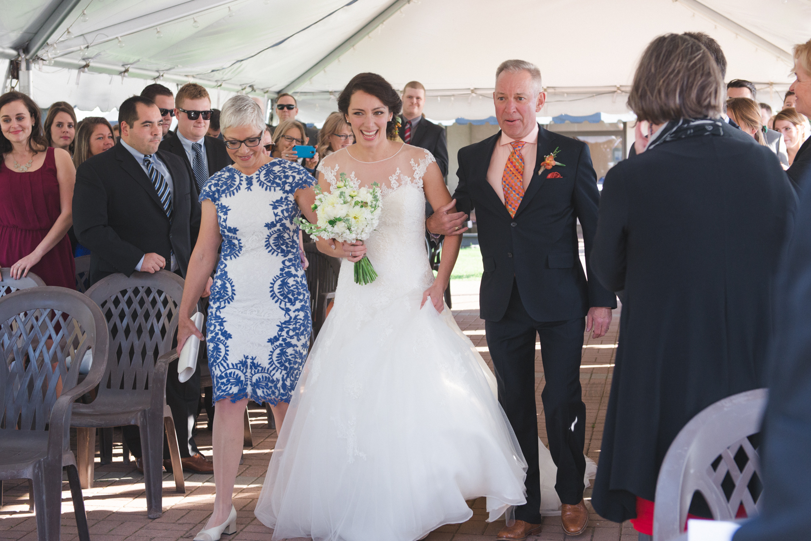 Bride walking down the aisle with her parents