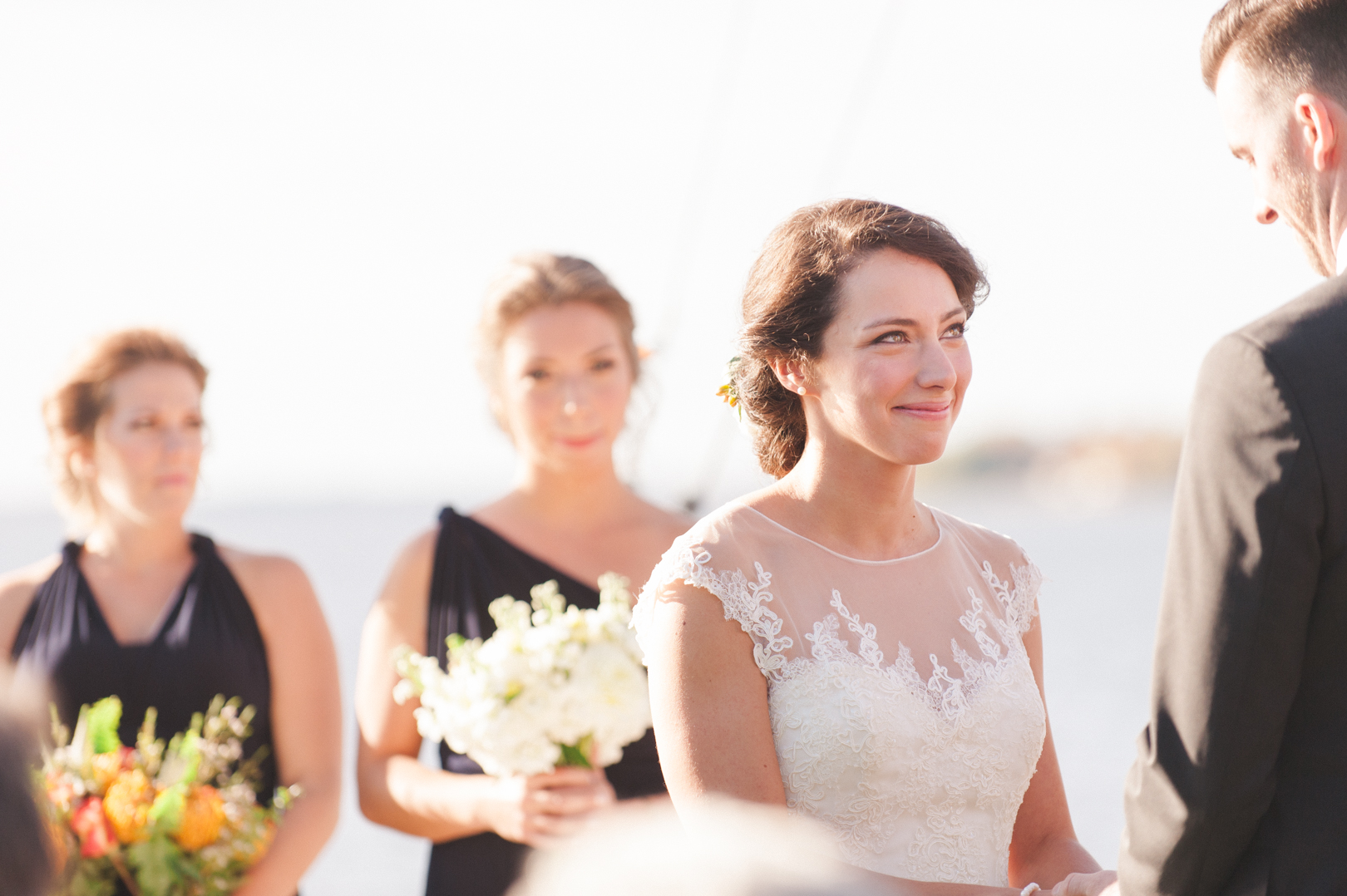 Bride smiling at her groom during the wedding ceremony