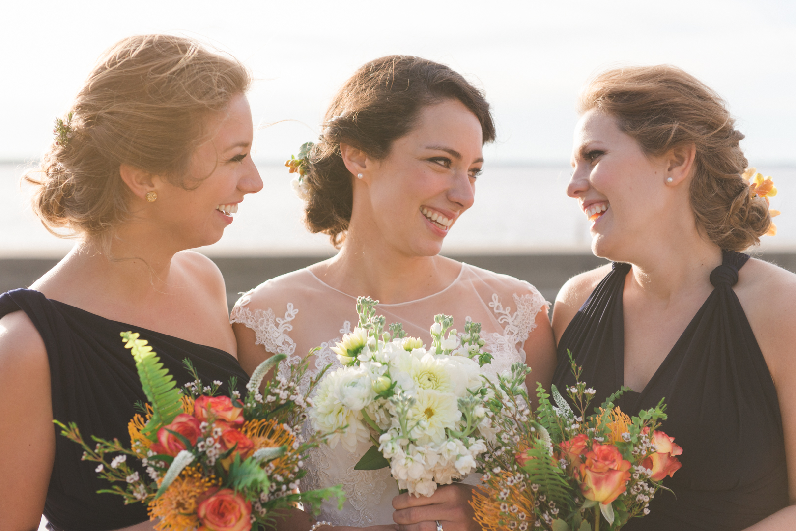 bride and bridesmaids laughing together