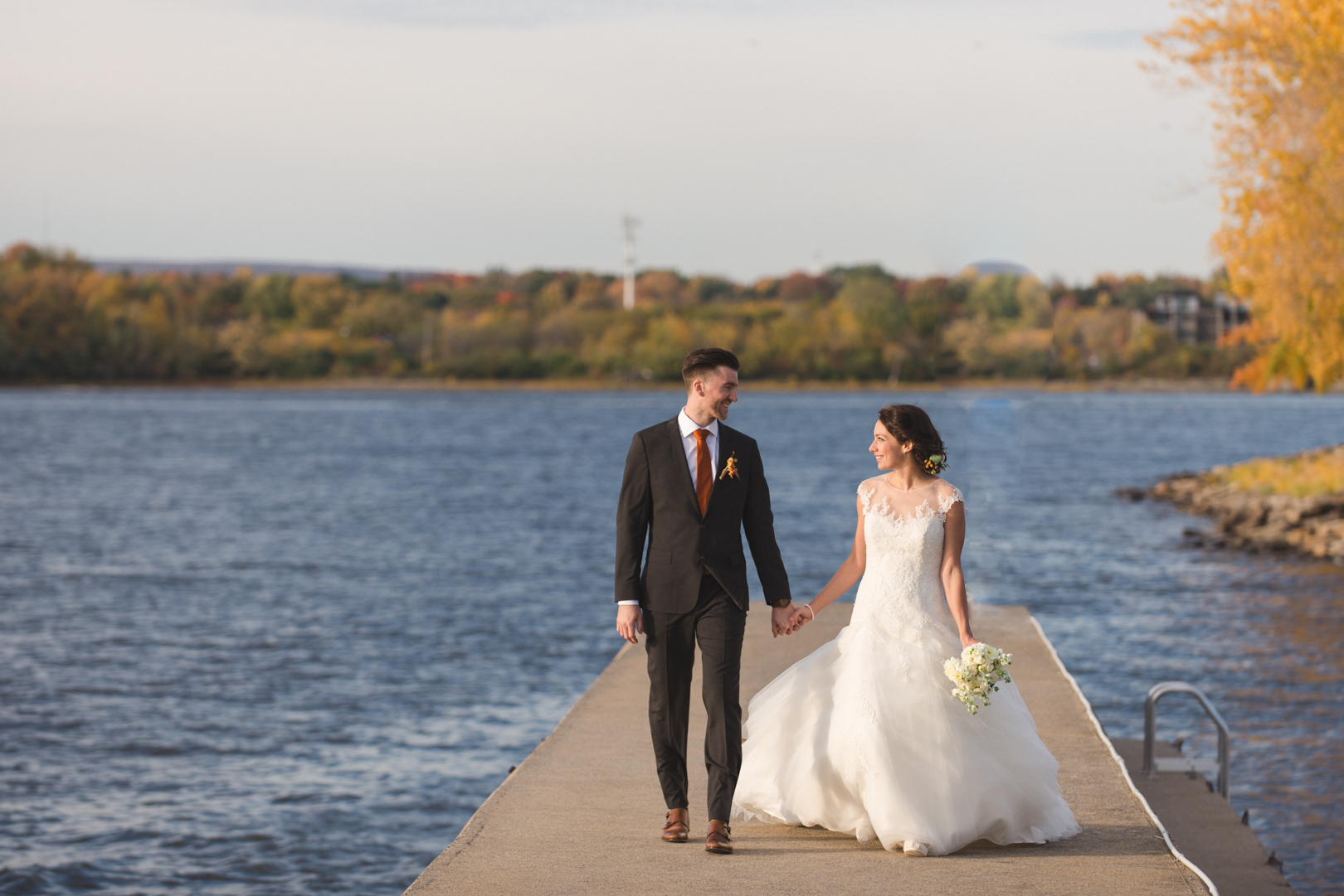 bride and groom walking along pier at Britannia Yacht Club