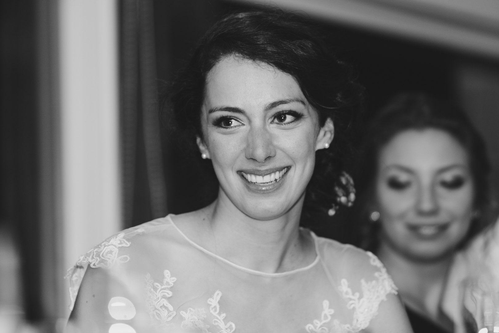 bride smiling at speeches