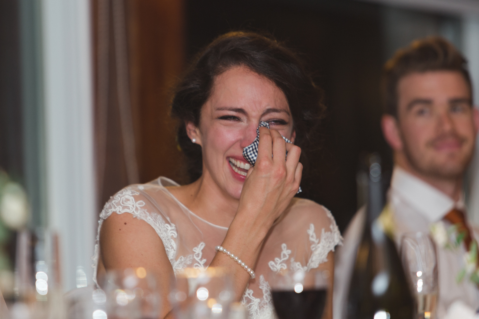 bride laughing so hard she is crying at speeches