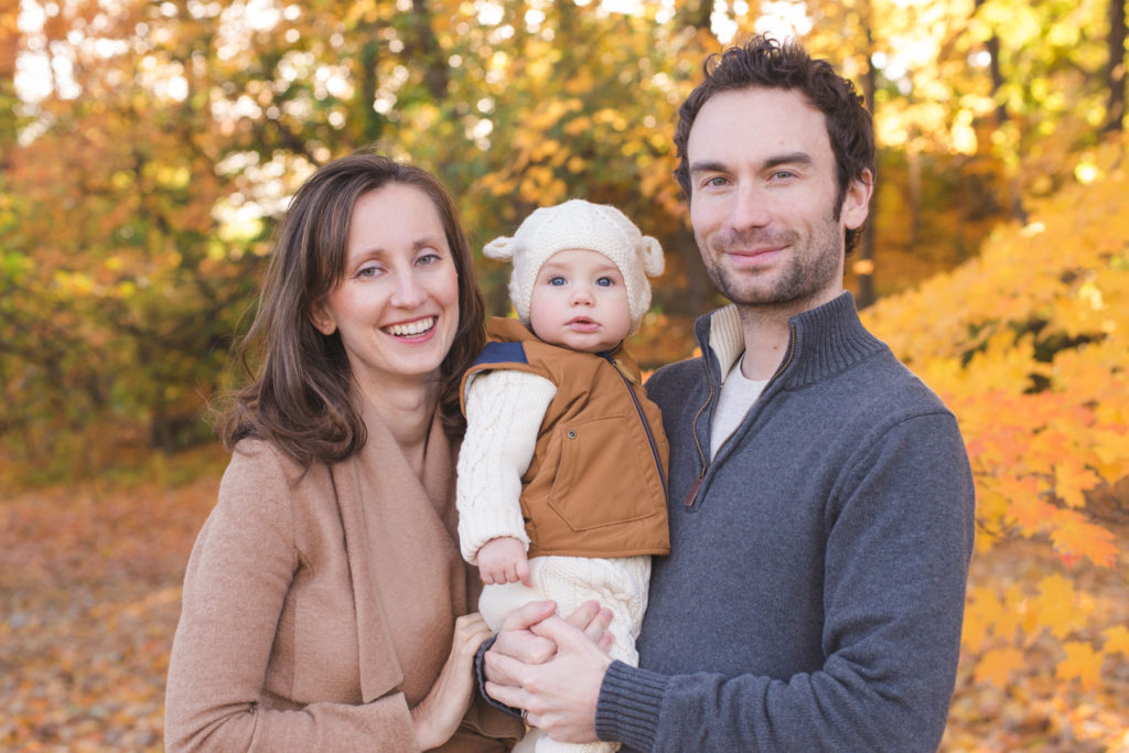 Parents and baby boy at the arboretum in ottawa on a fall day