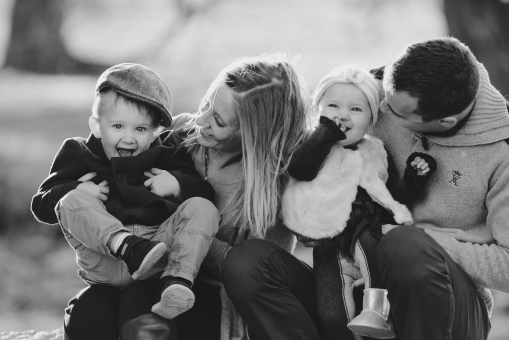 parents tickling their children and laughing