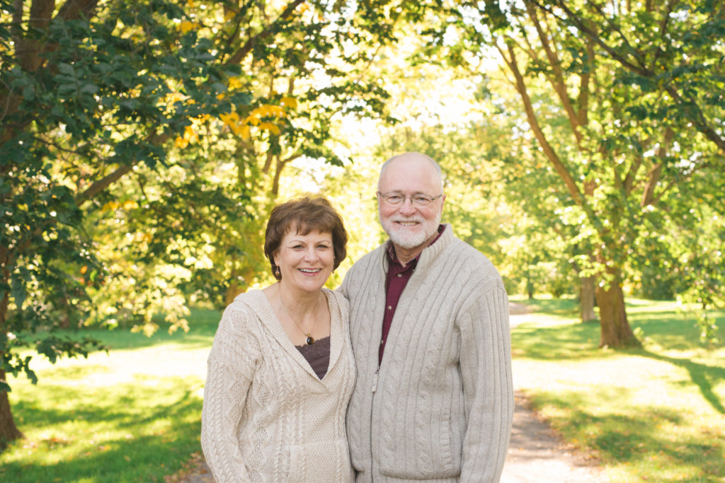 older couple together at the ottawa arboretum on a sunny fall day