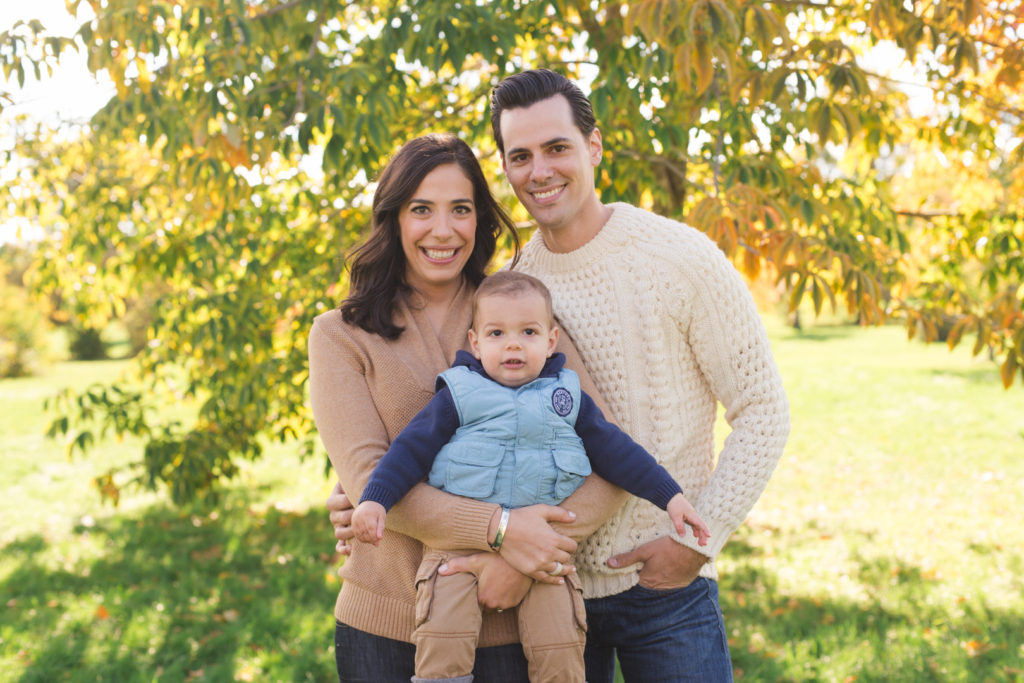 parents with baby boy on a sunny fall day at the arboretum