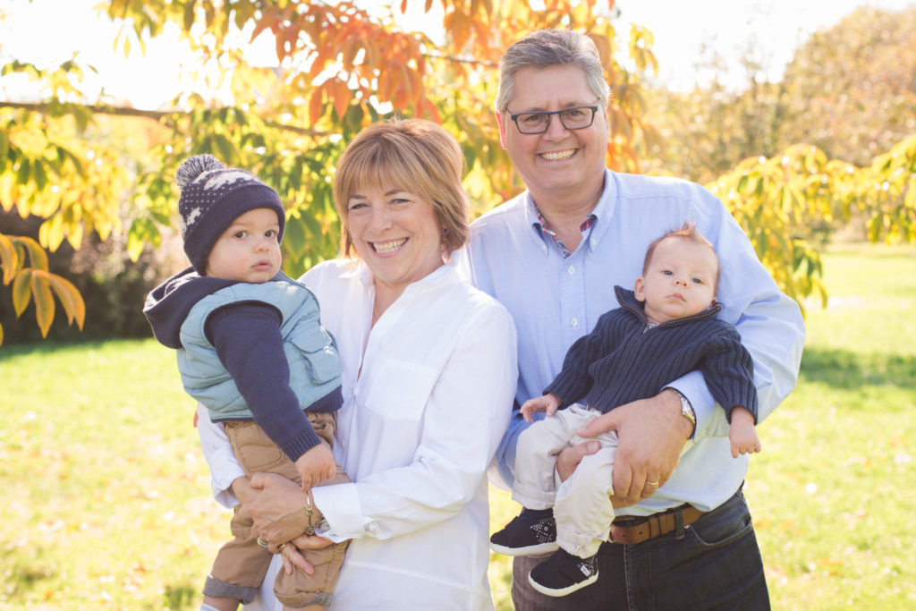 grandparents and their grandchildren on a sunny fall day at the arboretum