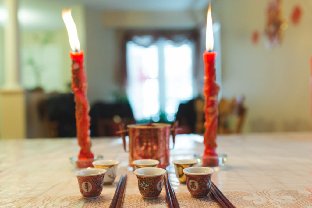 Chinese tea cups and red candles on the table before tea ceremony