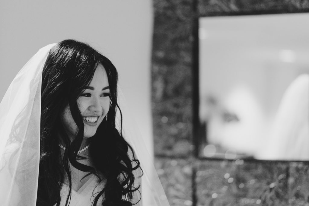 Bride laughing in black and white