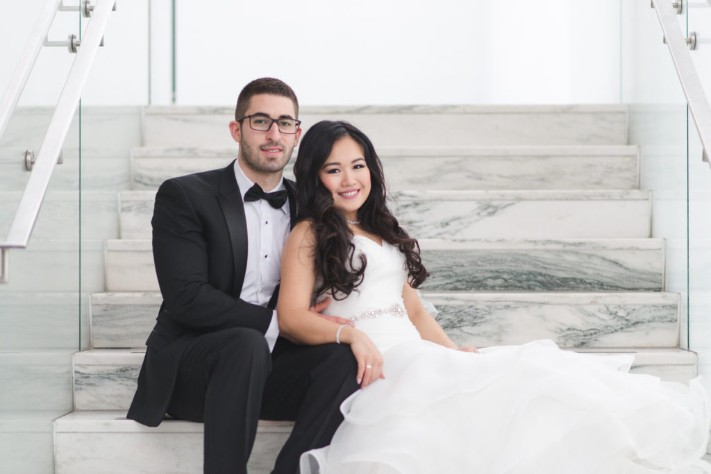 Bride and groom sitting on the staircase at the Museum of Nature in Ottawa