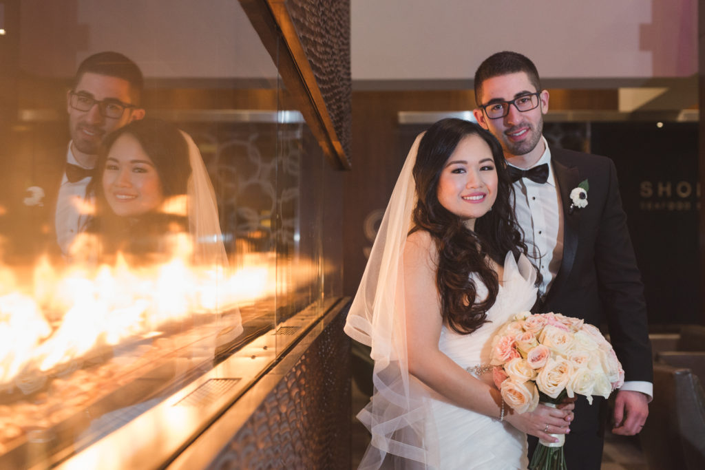 Bride and groom by the fire at the Westin Hotel in Ottawa