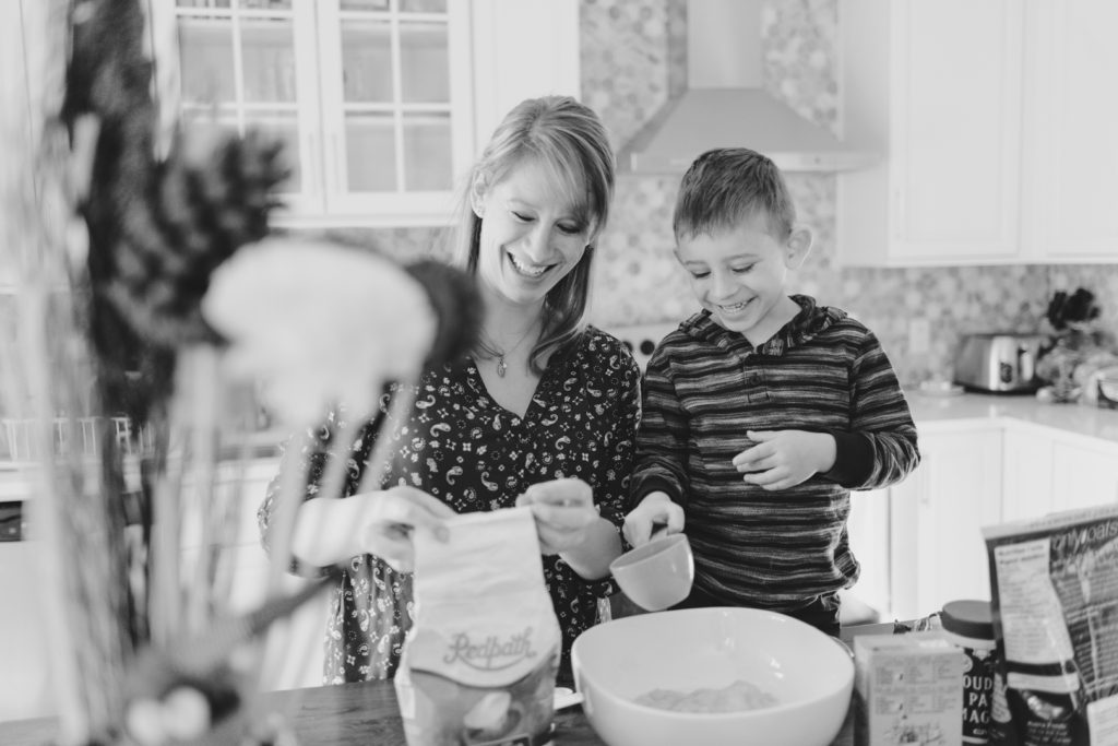boy helping mom bake muffins