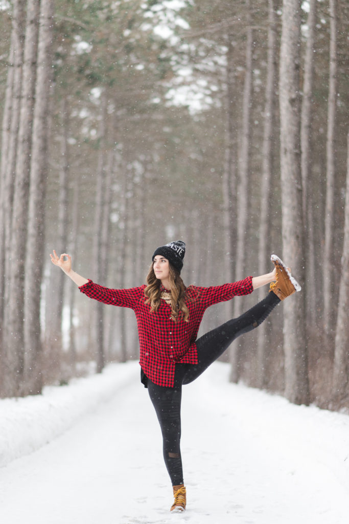 hand to big toe pose on snow covered path