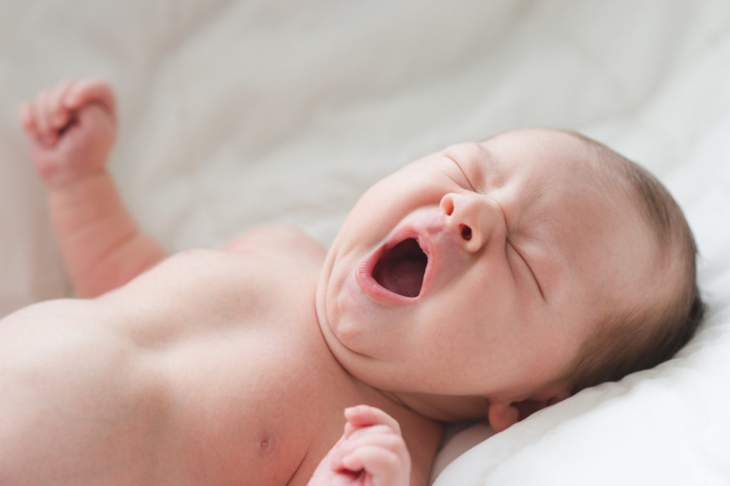 newborn baby boy yawning