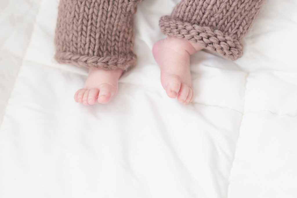 newborn baby boy toes with wool pants