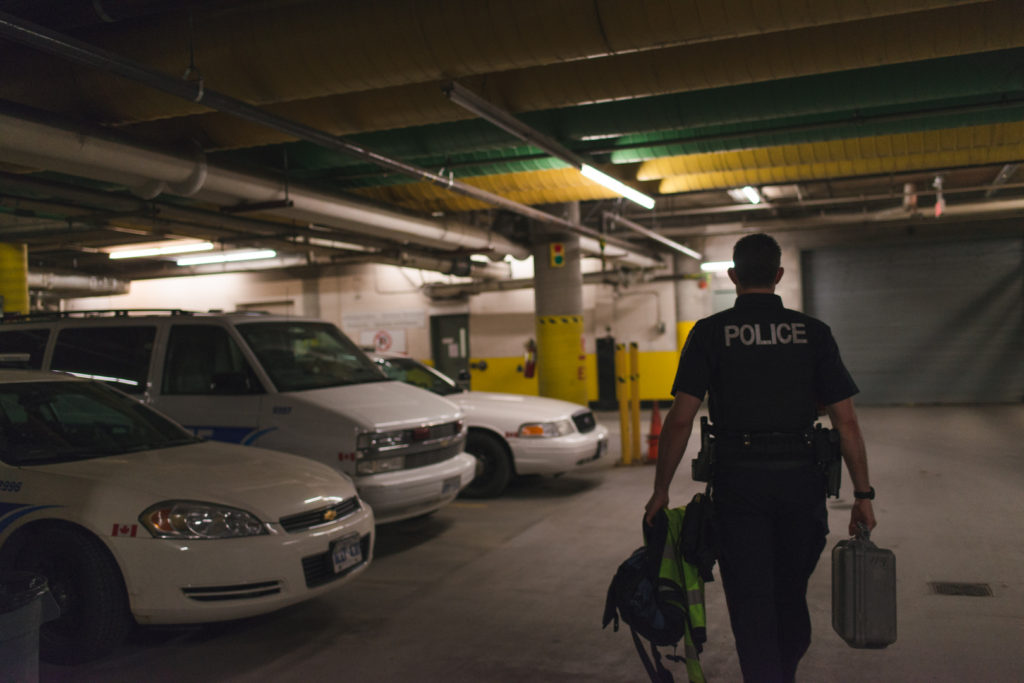 police officer heading out onto evening shift in the police department garage