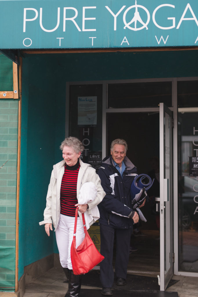 retired couple walking out of yoga class