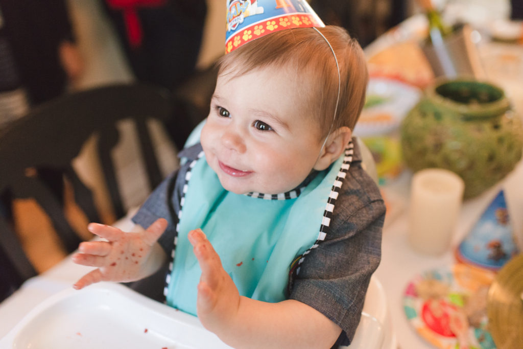 Eating his first birthday cake