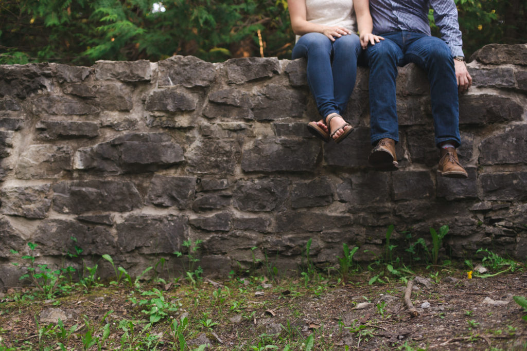 Couple sitting on stone wall at Lime Kiln Trail in Ottawa - Ashley Notley Photography