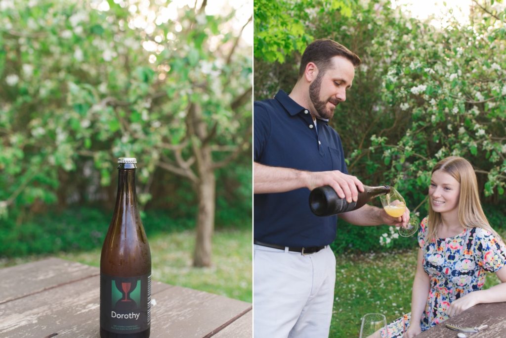 Couple pouring beer into fancy glasses in the garden