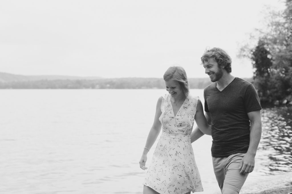 couple walking together on the beach by the lake