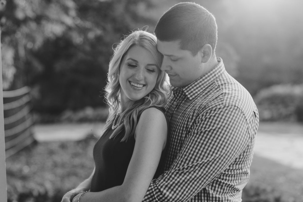 photo of couple cuddling in black and white at sunset