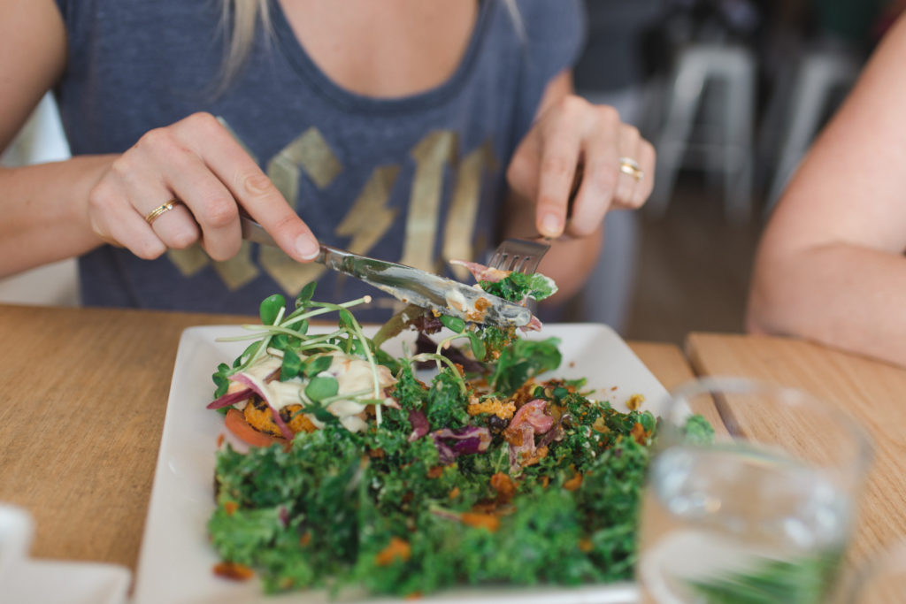 Amber Stratton eating kale salad at Pure Kitchen