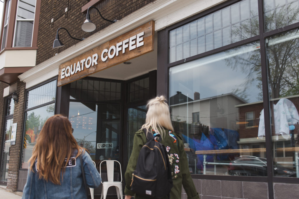 Amber Stratton and Jen Dalgleish walking into Equator Coffee in Westboro