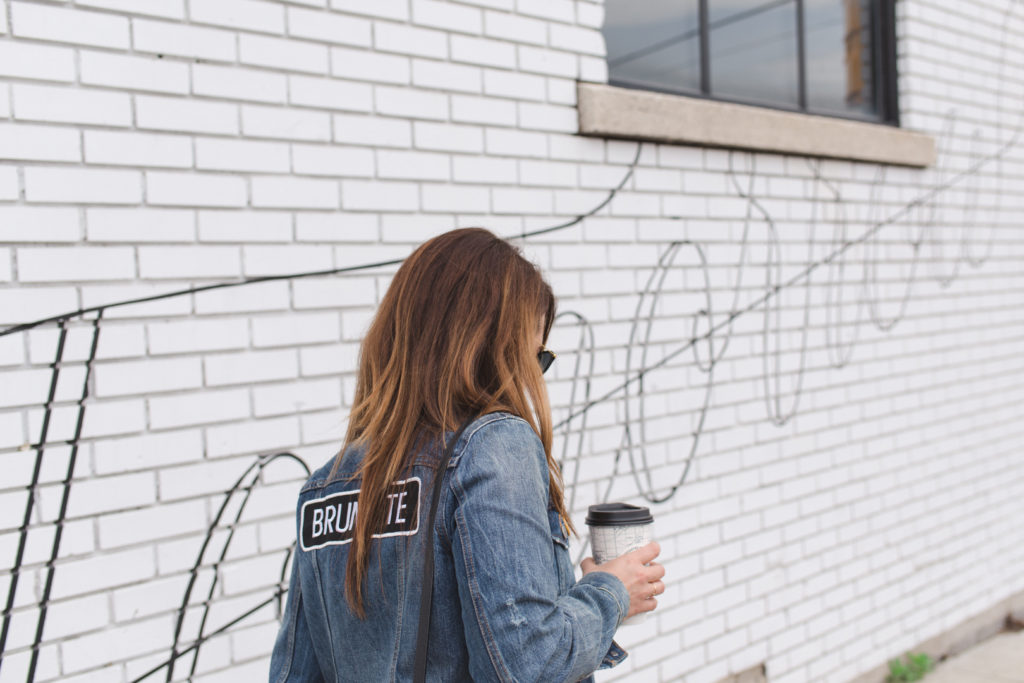 Jen Dalgleish wearing Brunette jean jacket holding coffee