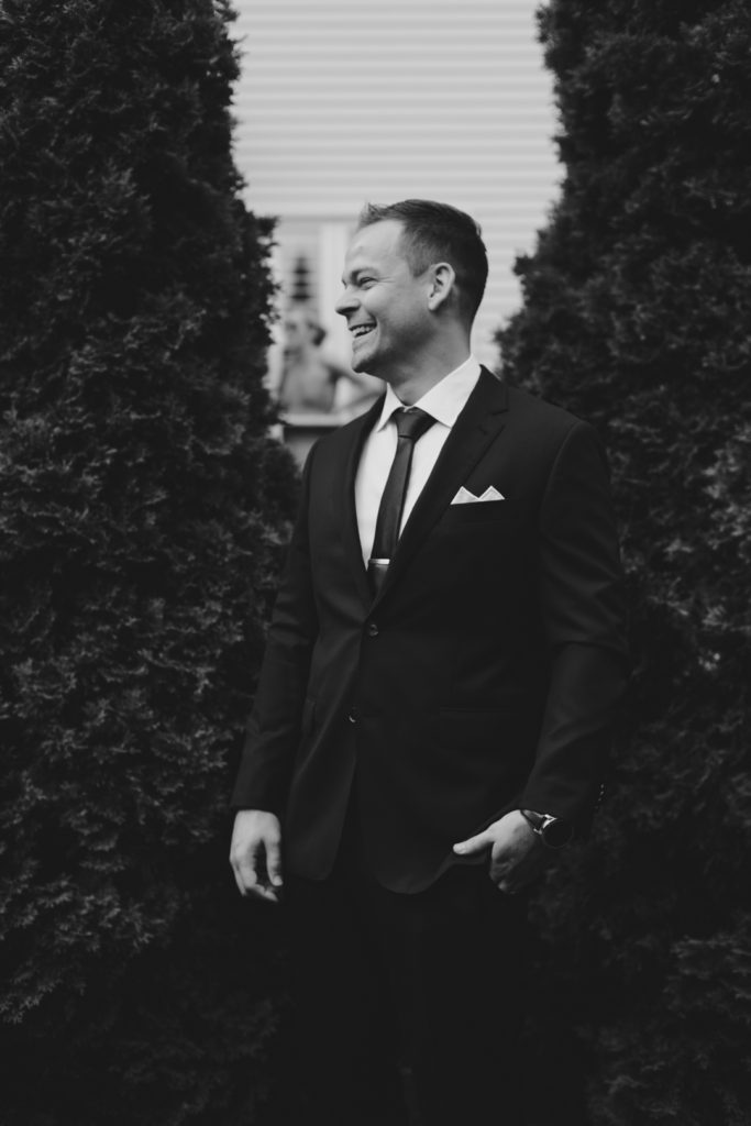 black and white photo of groom smiling