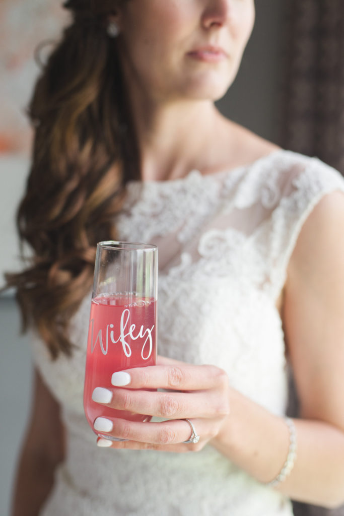 bride holding "wifey" champagne flute