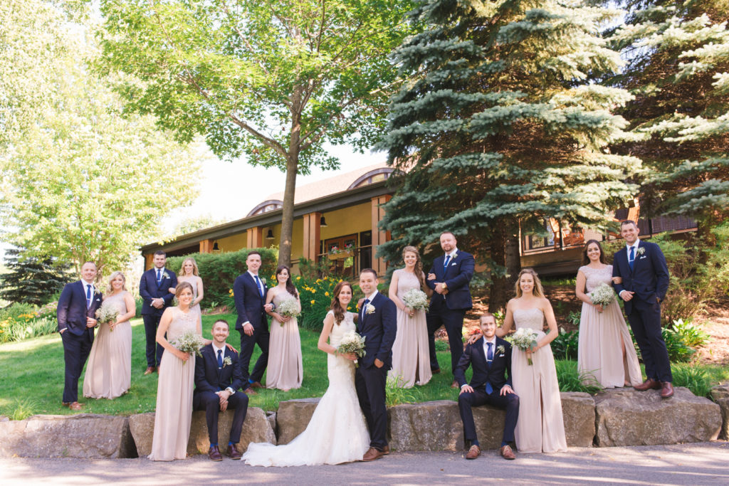wedding party posed in front of the marshes golf club