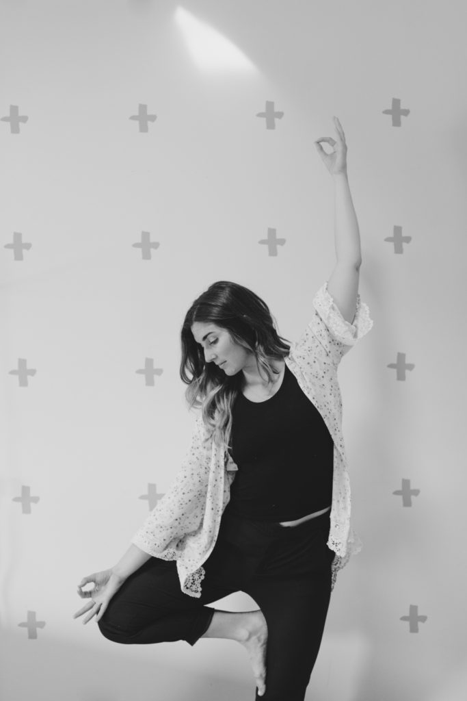 yoga teacher in tree pose in black and white