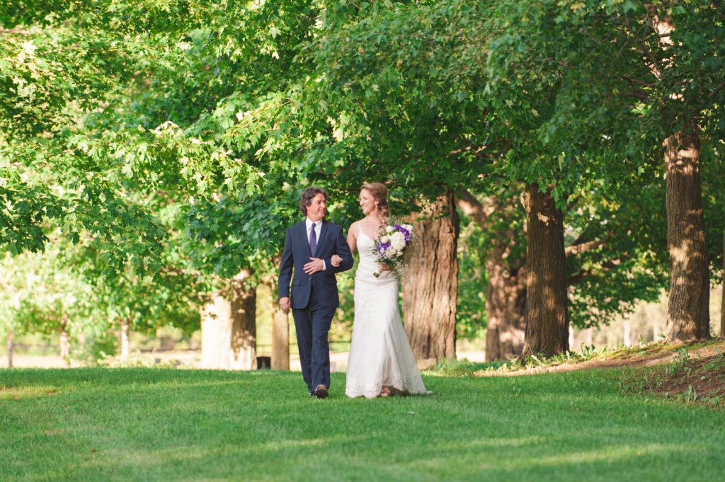 bride and her father walking down the aisle outdoors