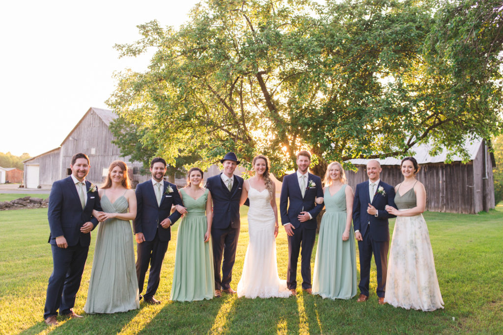 wedding party in sage green at sunset