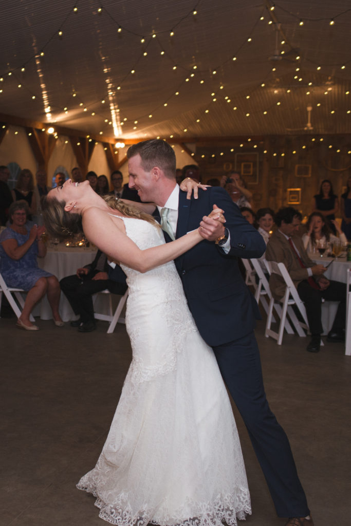 bride and groom first dance among twinkly lights