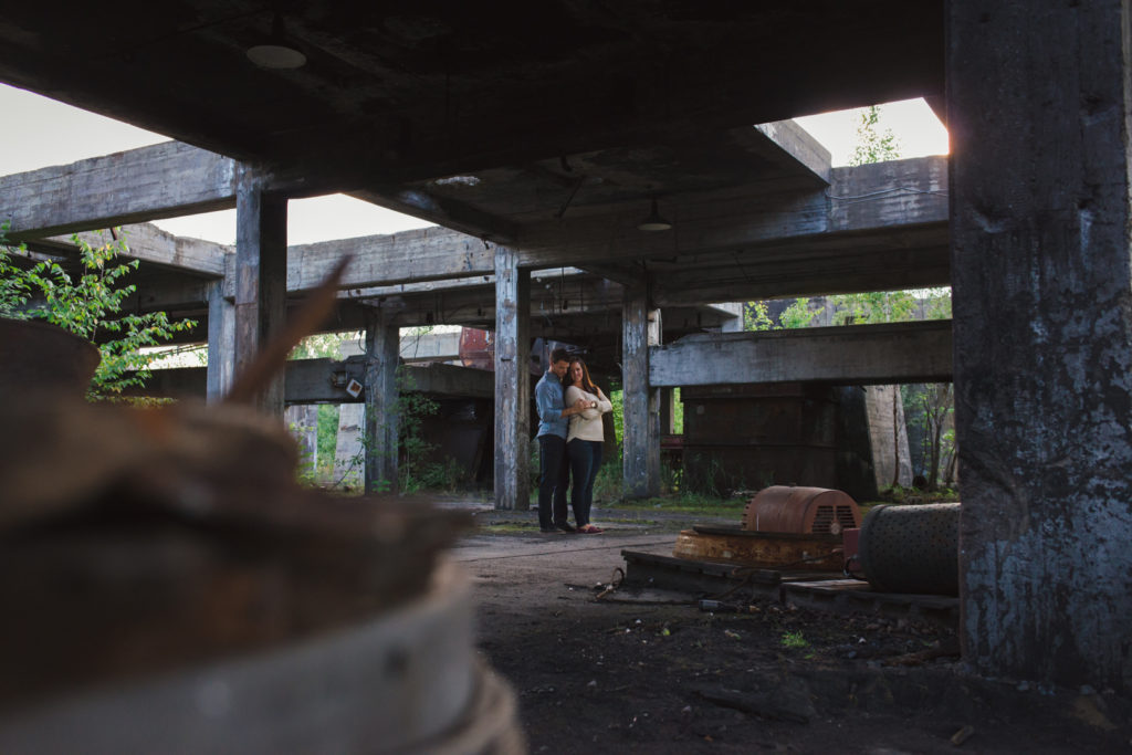 engaged couple standing among abandoned mine ruins