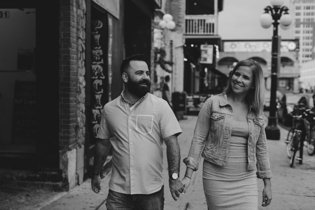 engaged couple walking down york street in the byward market holding hands