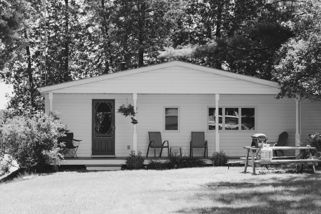 black and white photo of the outside of a family cottage